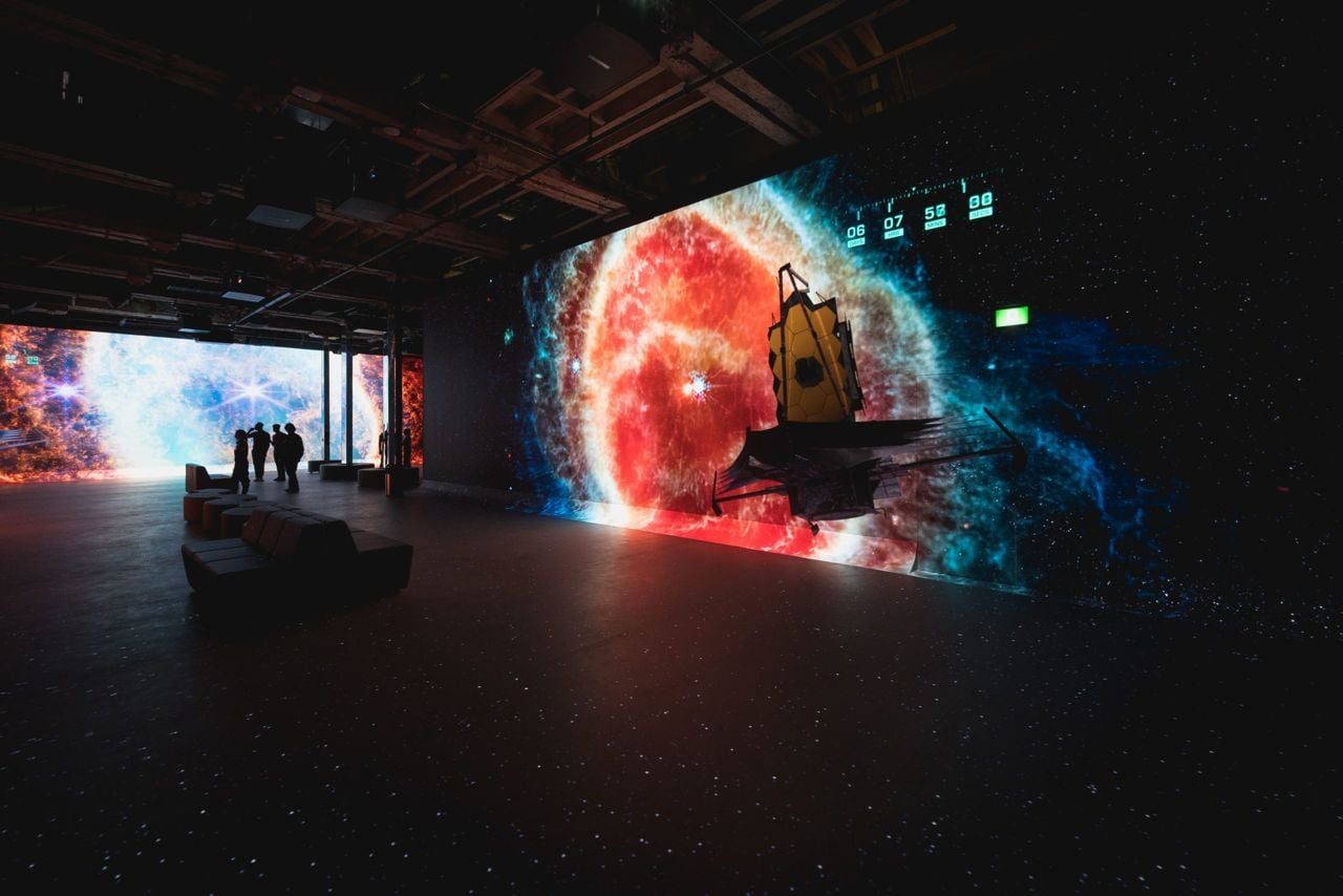 Star-sky themed projection filling an exhibition hall with immersive atmosphere