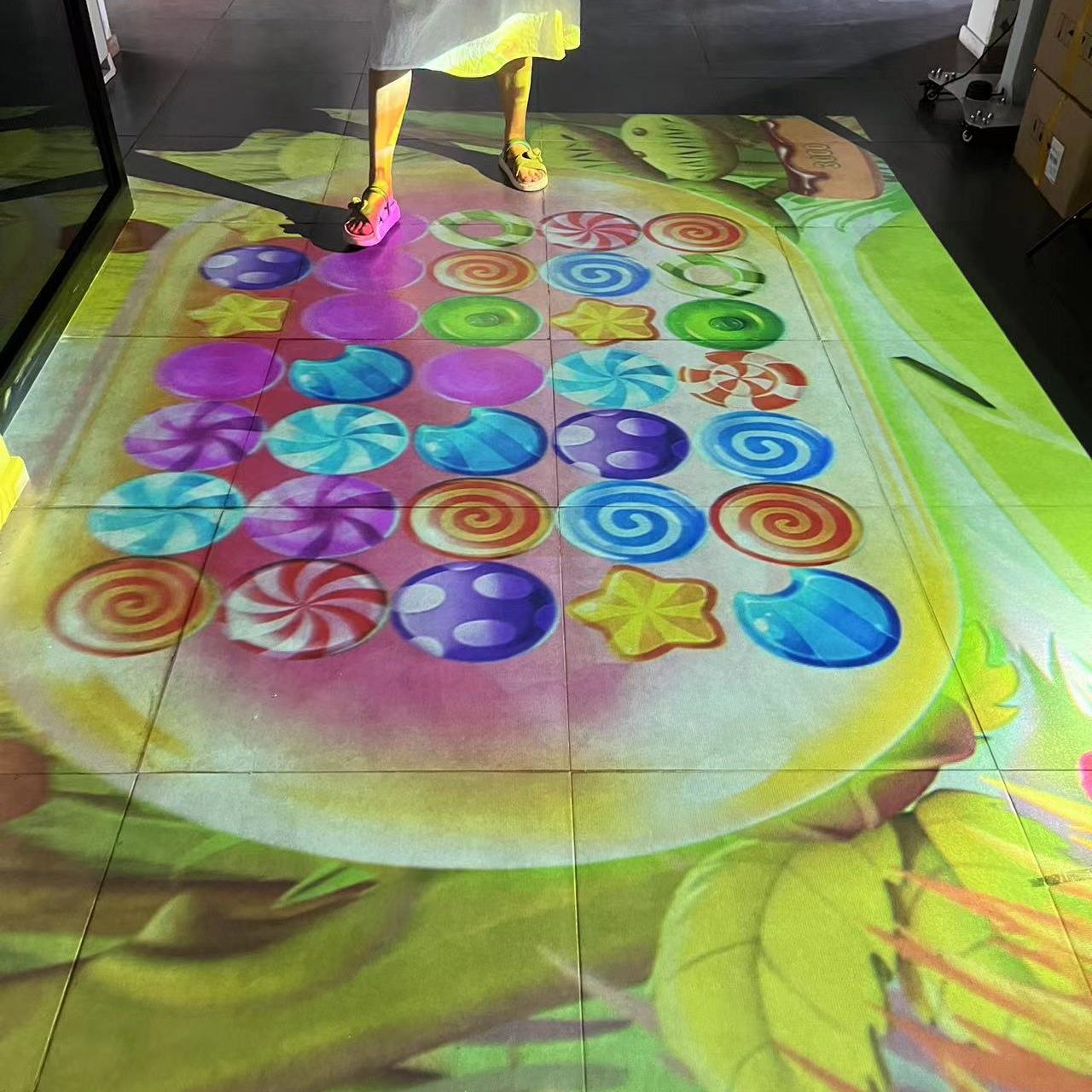 Visitors standing on a colorful projection matching game cast on the floor