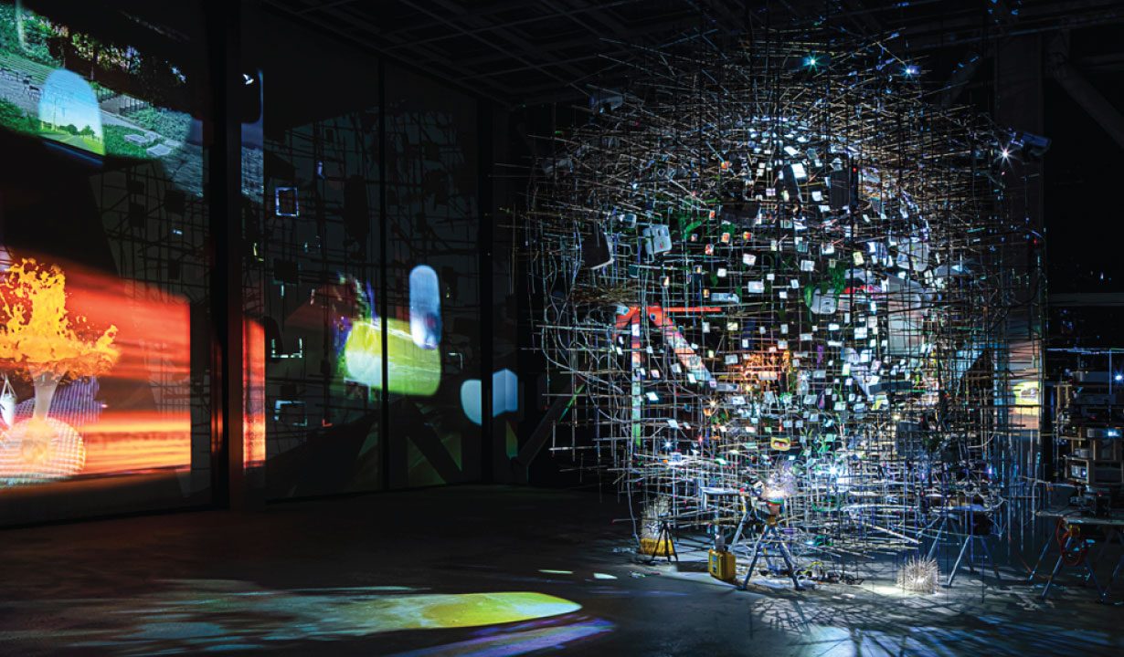 Large multimedia projection installation with structured art scenes in a dark hall