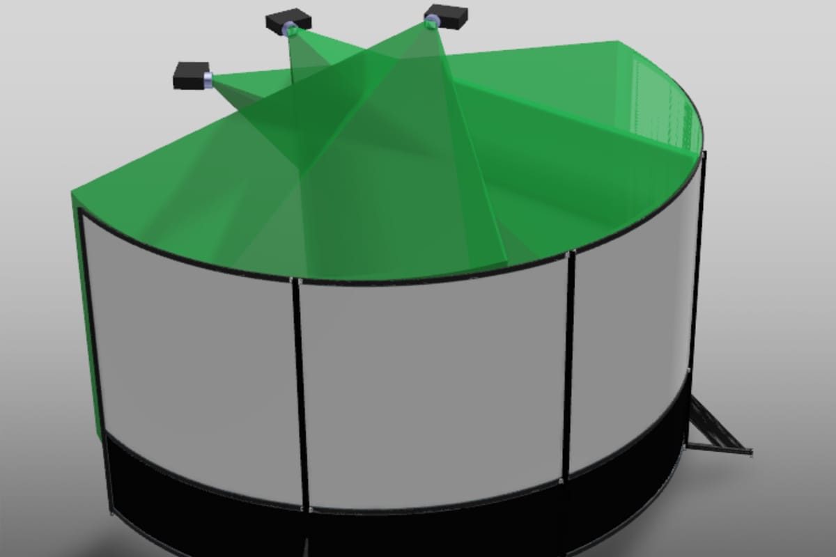 Three projector light cones overlapping on a cylindrical screen to form blend bands
