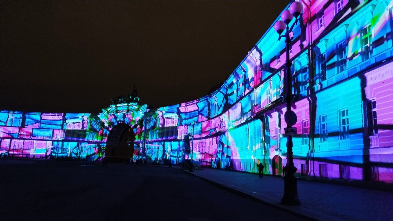 A classical European facade lit by colorful projection as a night landmark