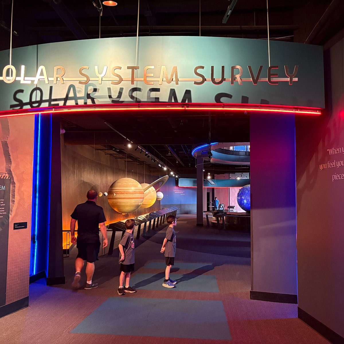 Solar system themed science center zone with suspended planet models
