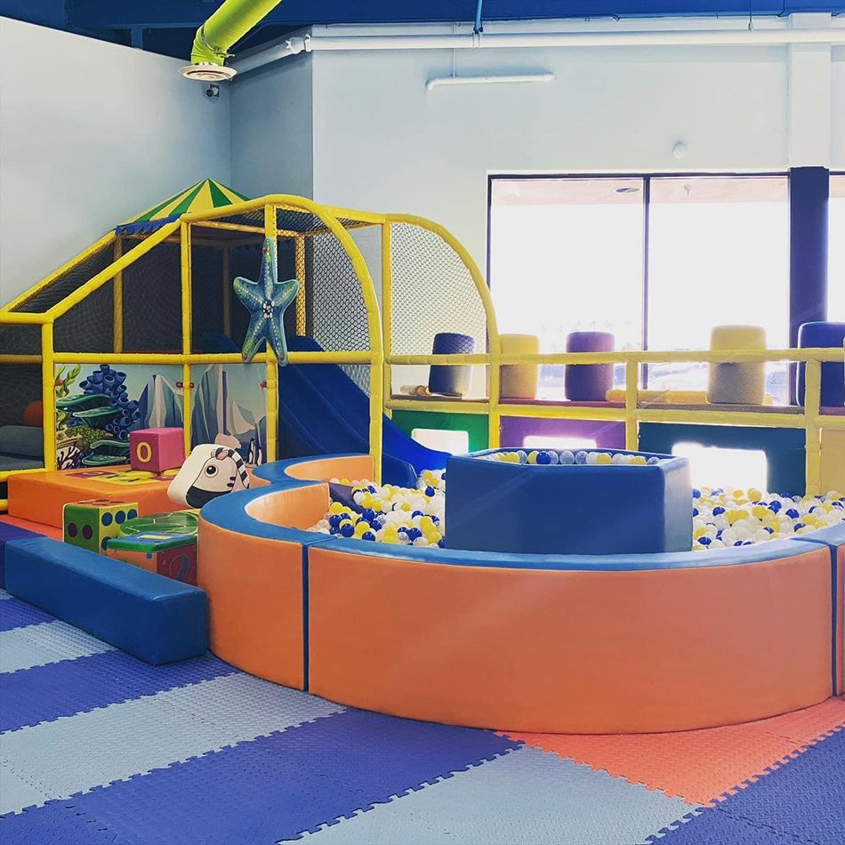 Bright children's playground scene with slide and ocean ball pool
