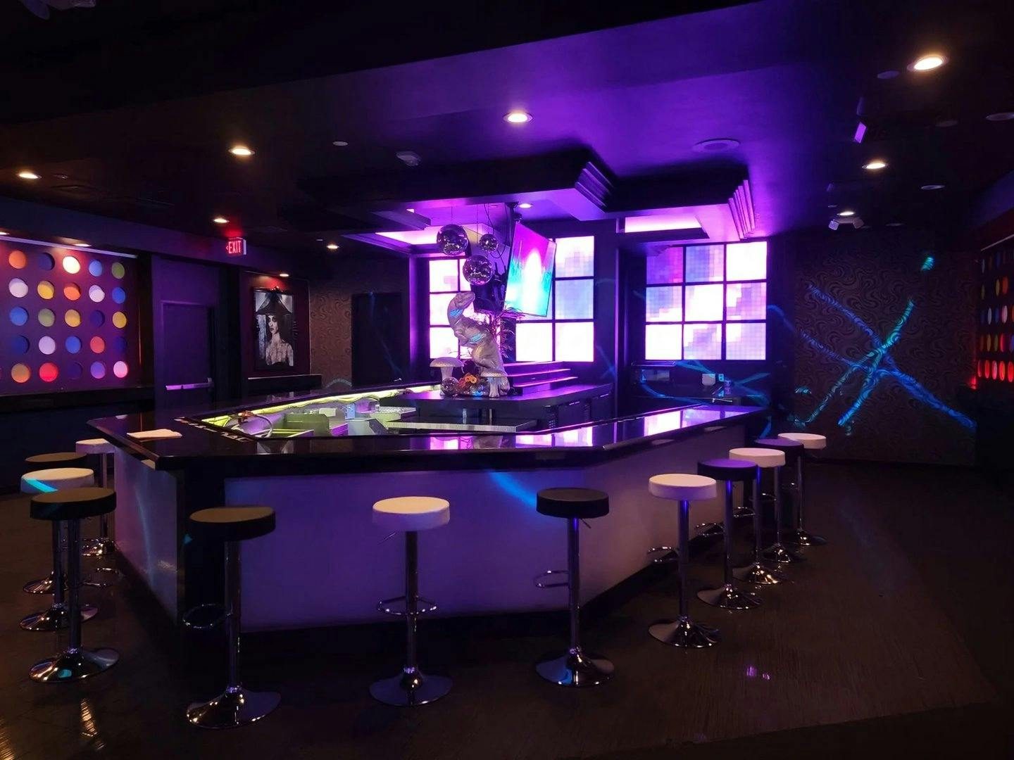 Quiet lounge bar with purple projection light and LED wall ambiance