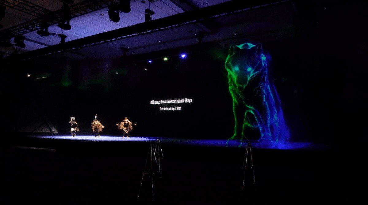 Dancer performing with a glowing holographic wolf on stage