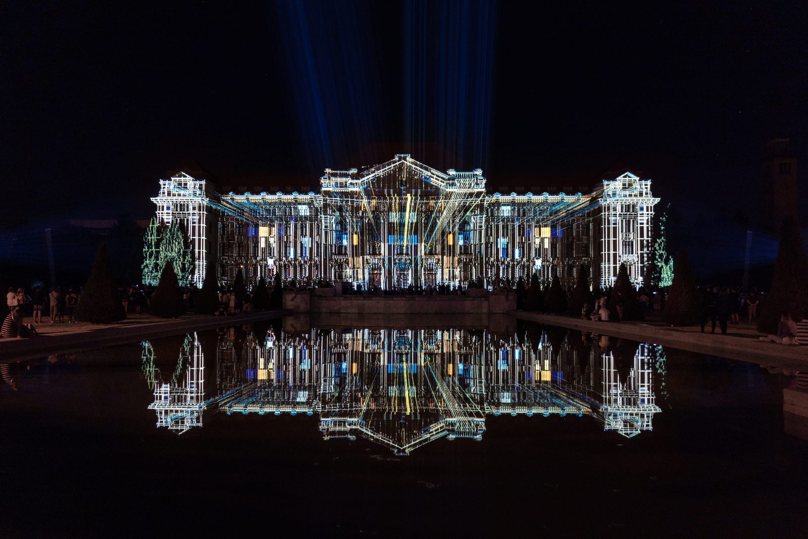 Palace facade projection show mirrored in the water below